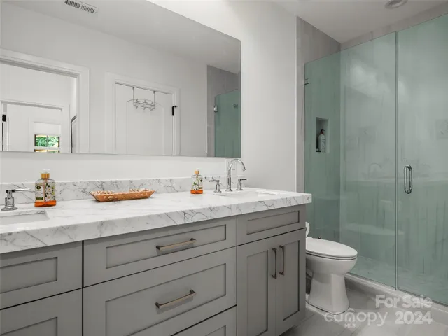 a living room with furniture and wall paintings