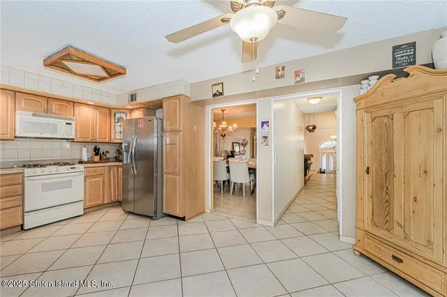 a kitchen with a refrigerator a microwave and cabinets