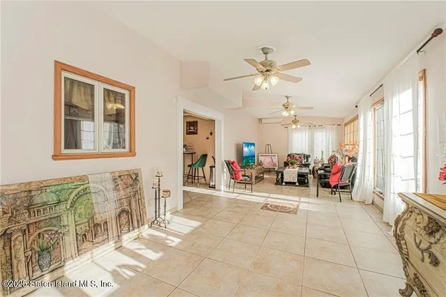 a view of a livingroom with furniture and a ceiling fan