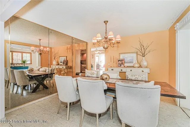 a view of a dining room with furniture and chandelier