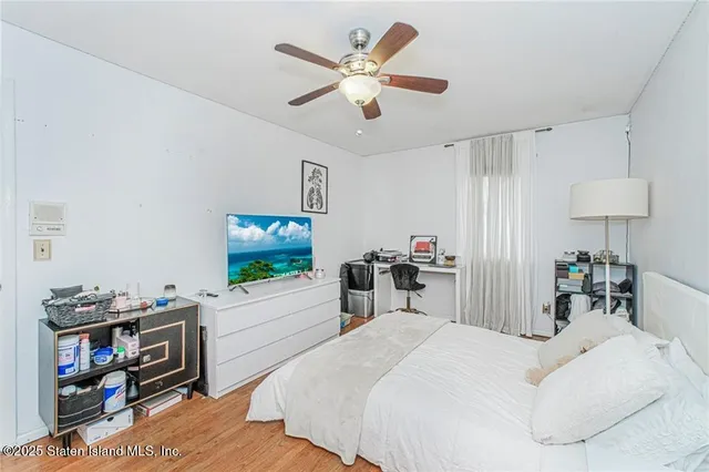 a bedroom with furniture a bed and a flat screen tv