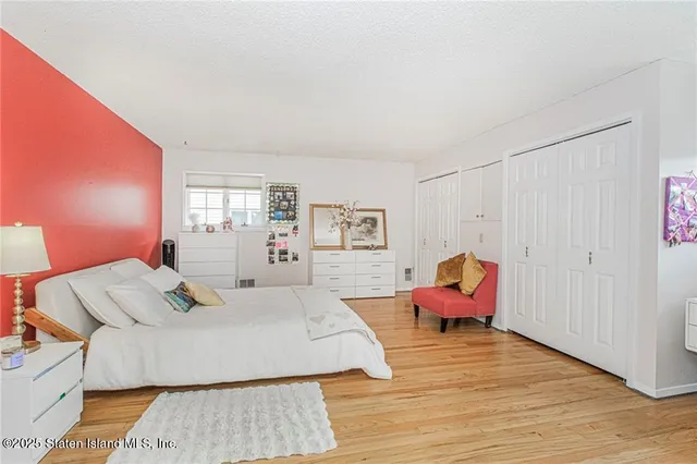 a bedroom with furniture and wooden floor
