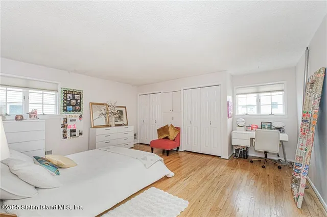a bedroom with furniture and wooden floor