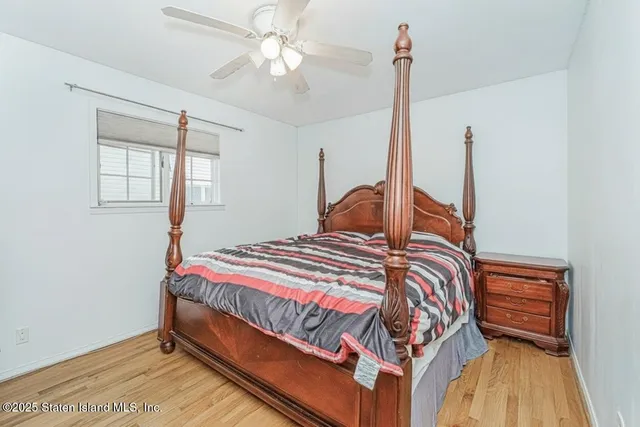 a bedroom with a bed next to a window