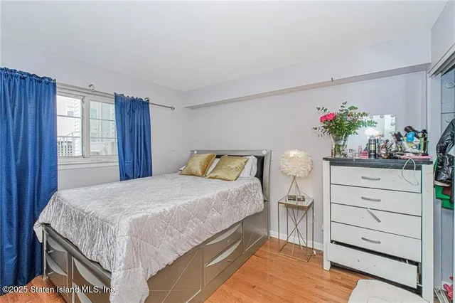 a bedroom with a bed and a potted plant