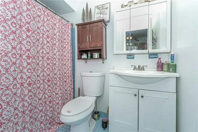 a bathroom with a sink toilet and mirror