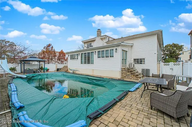 a view of a house with backyard porch and sitting area