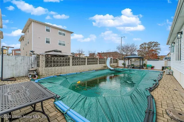 swimming pool view with a seating space