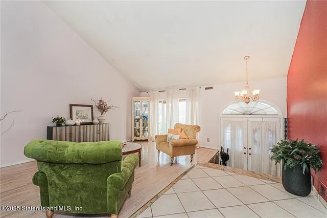 a living room with furniture and a chandelier