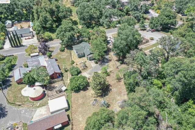 an aerial view of a house with table and chairs