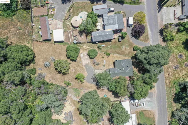 an aerial view of house with yard swimming pool and outdoor seating