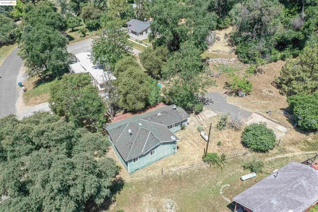 an aerial view of a house with yard