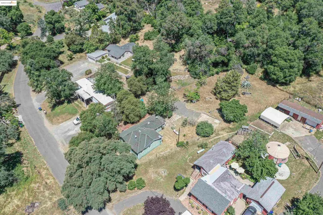 an aerial view of a residential houses with outdoor space