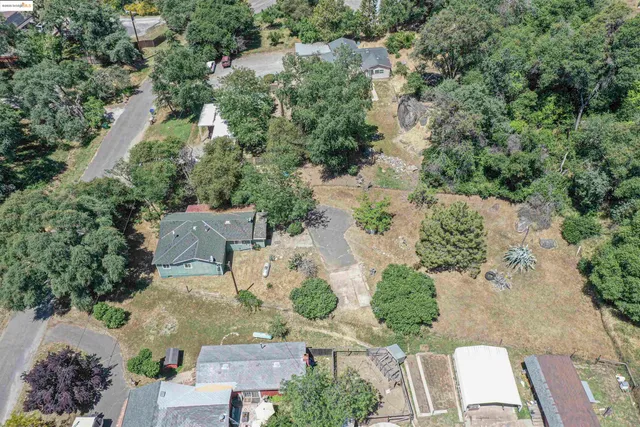 an aerial view of a house with yard