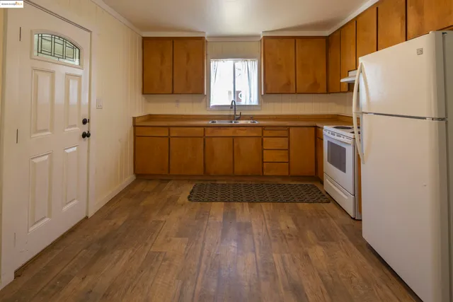 a kitchen with a refrigerator sink and cabinets