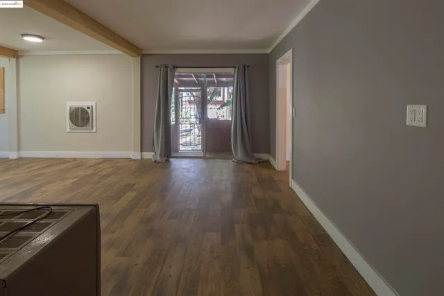 wooden floor in an empty room with a window