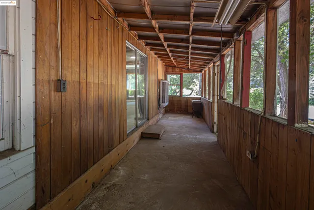 a view of hallway with balcony and outdoor shower