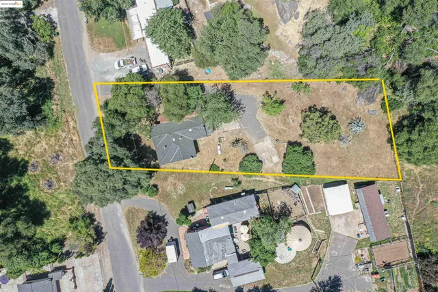 an aerial view of a house with outdoor space