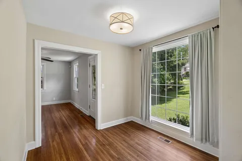 a view of room with window and wooden floor