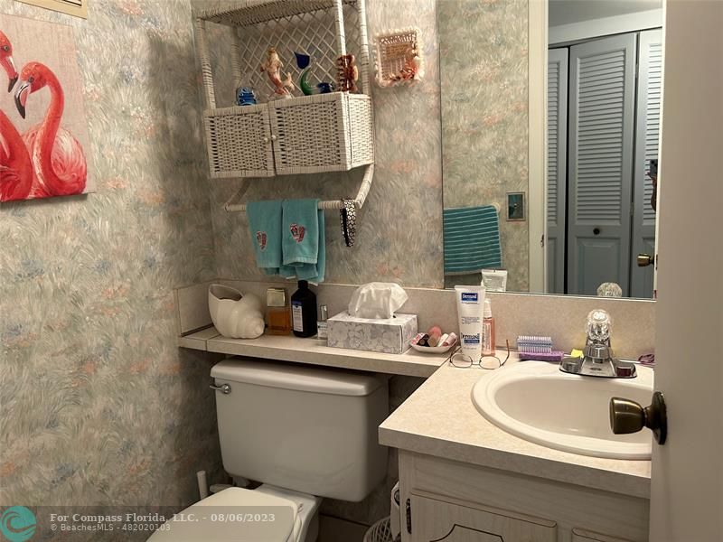 30 Tilford B, Unit 30 Deerfield Beach, FL 33442 - Photo 12 of 23 a bathroom with a sink mirror and toilet