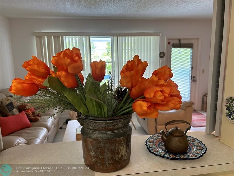 30 Tilford B, Unit 30 Deerfield Beach, FL 33442 - Photo 17 of 23 a vase of flowers sitting on a floor