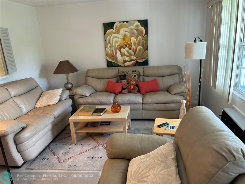30 Tilford B, Unit 30 Deerfield Beach, FL 33442 - Photo 20 of 23 a living room with furniture and a couch
