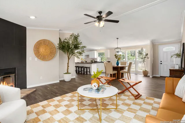 a living room with furniture a dining table and a fireplace