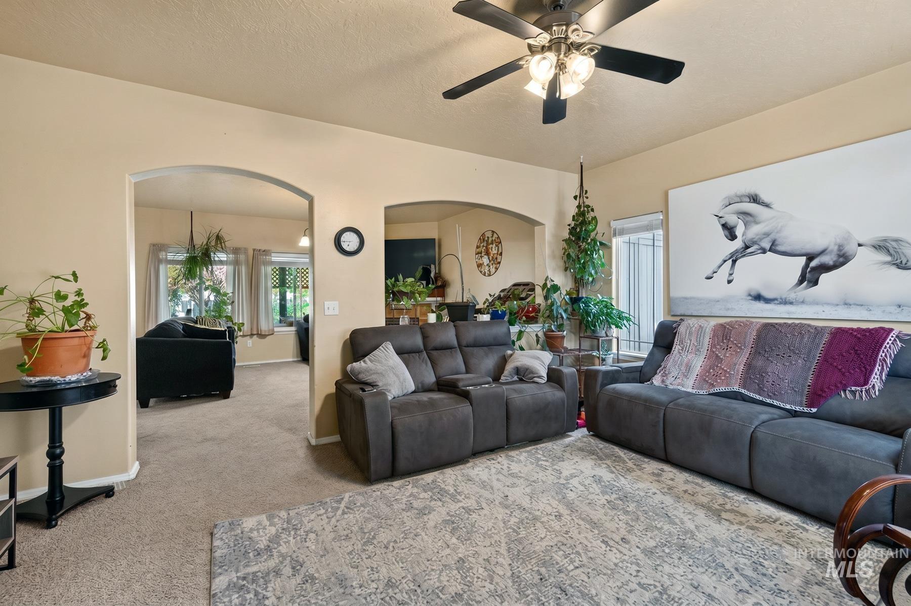5020 Northrup Way Caldwell, ID 83607 - Photo 8 of 36 Expansive living area with neutral-toned walls and carpet flooring