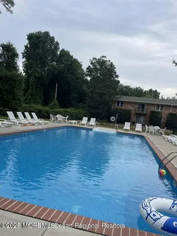 a view of a lake with chairs