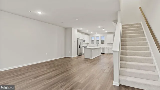 a view of kitchen with wooden floor and windows