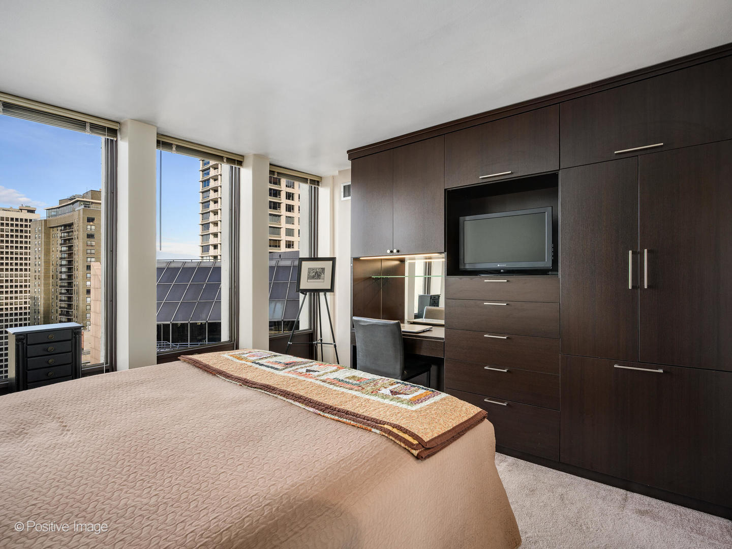 100 East Walton Street, Unit 32B Chicago, IL 60611 - Photo 11 of 17 a bedroom with a bed and a television in it