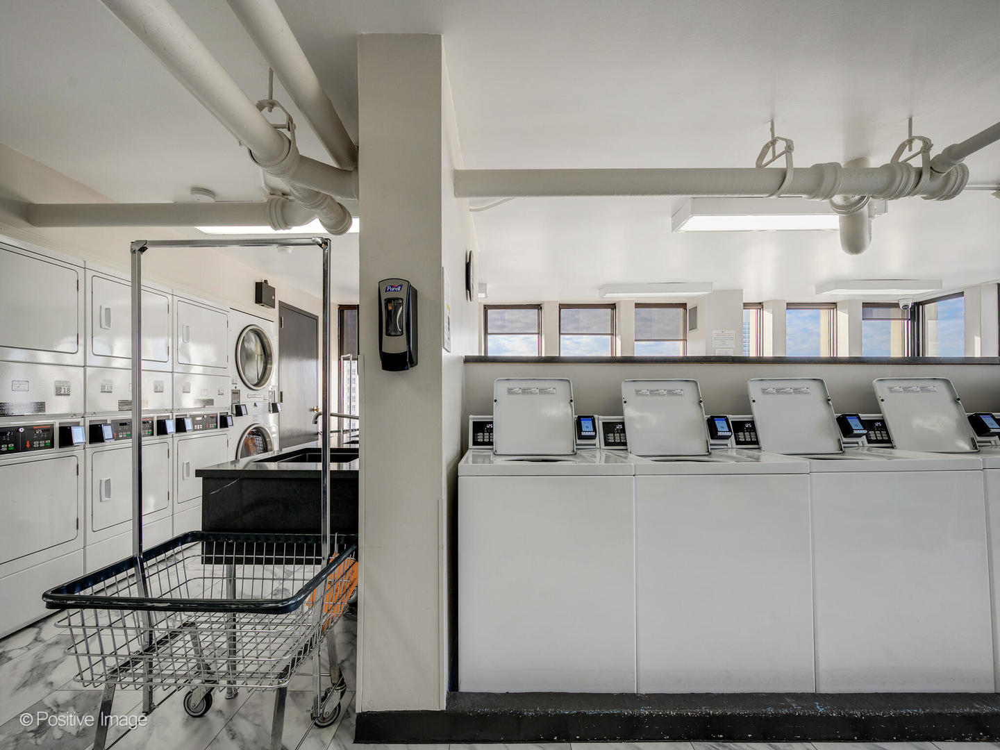 100 East Walton Street, Unit 32B Chicago, IL 60611 - Photo 16 of 17 a kitchen with cabinets and window