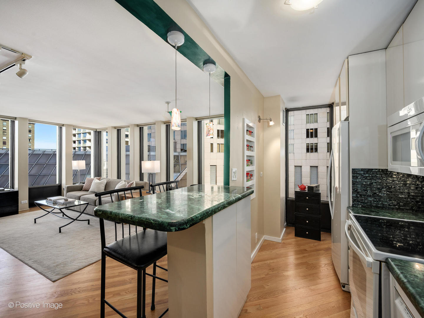 100 East Walton Street, Unit 32B Chicago, IL 60611 - Photo 7 of 17 a kitchen with stainless steel appliances granite countertop a stove and a table