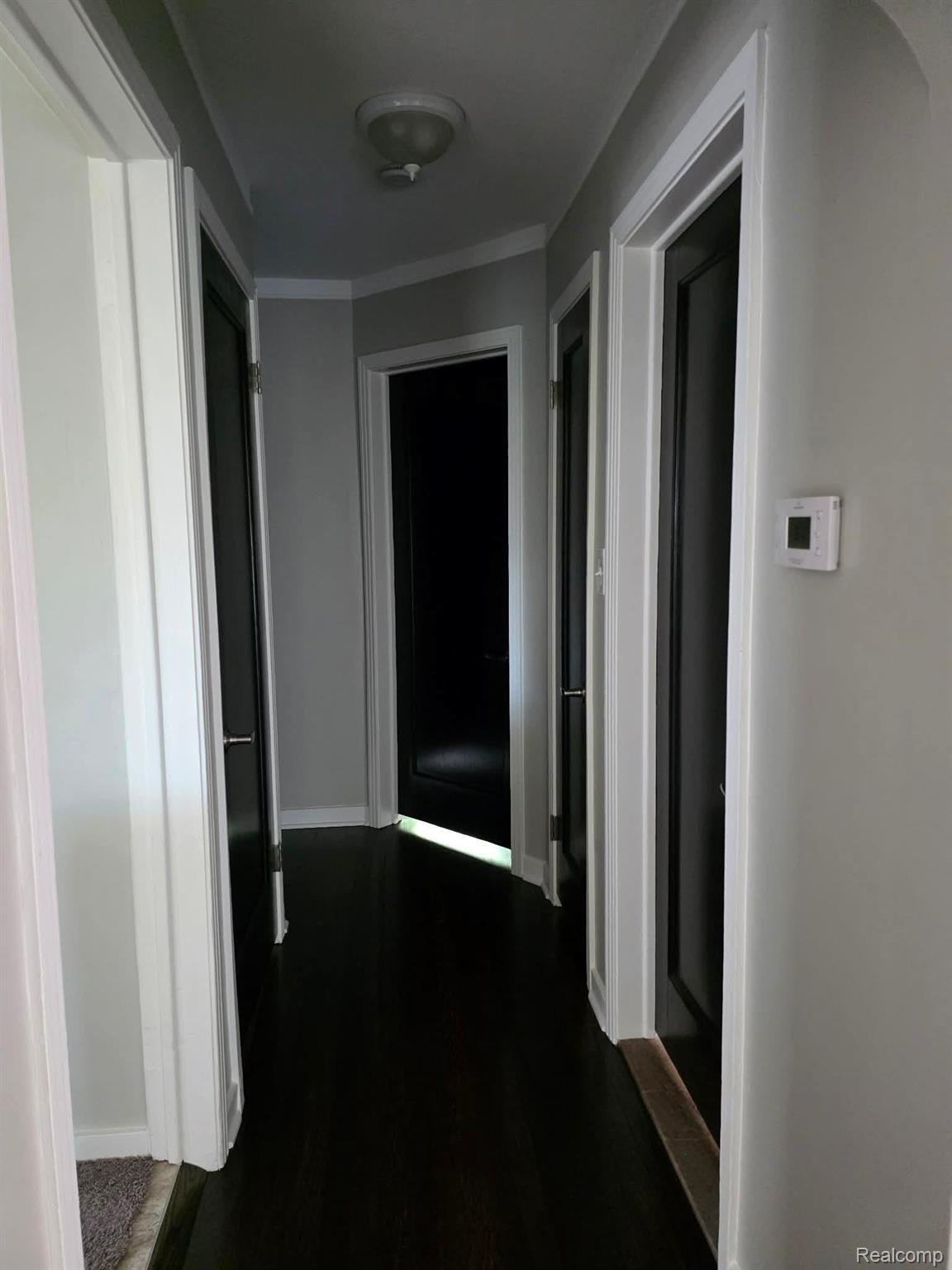 29571 Kelly Road Roseville, MI 48066 - Photo 13 of 27 Hallway with baseboards and dark wood finished floors