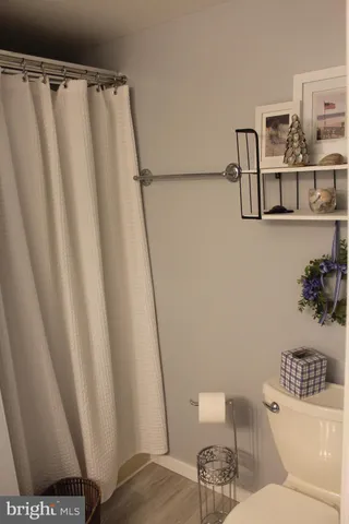 a white toilet sitting next to a sink