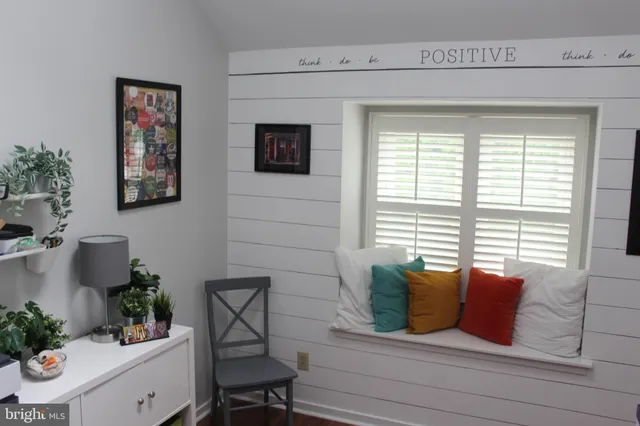 a bathroom with a bathtub and a potted plant