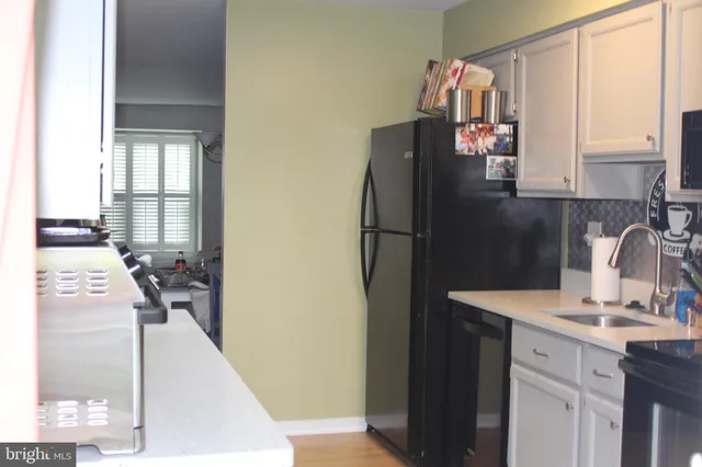 a kitchen with a refrigerator and a sink