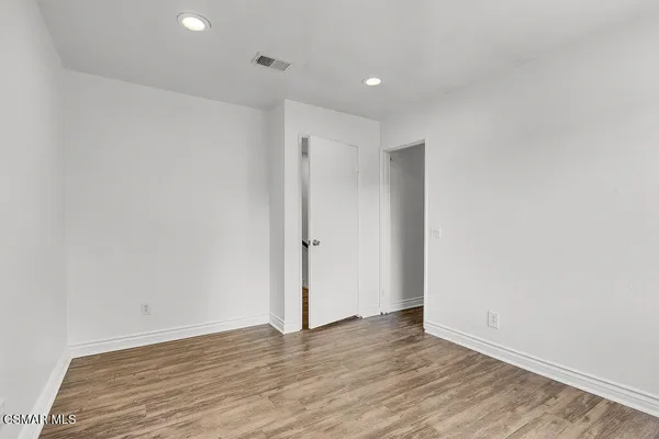 a utility room with wooden floor washer and dryer