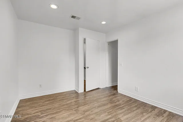 a utility room with wooden floor washer and dryer