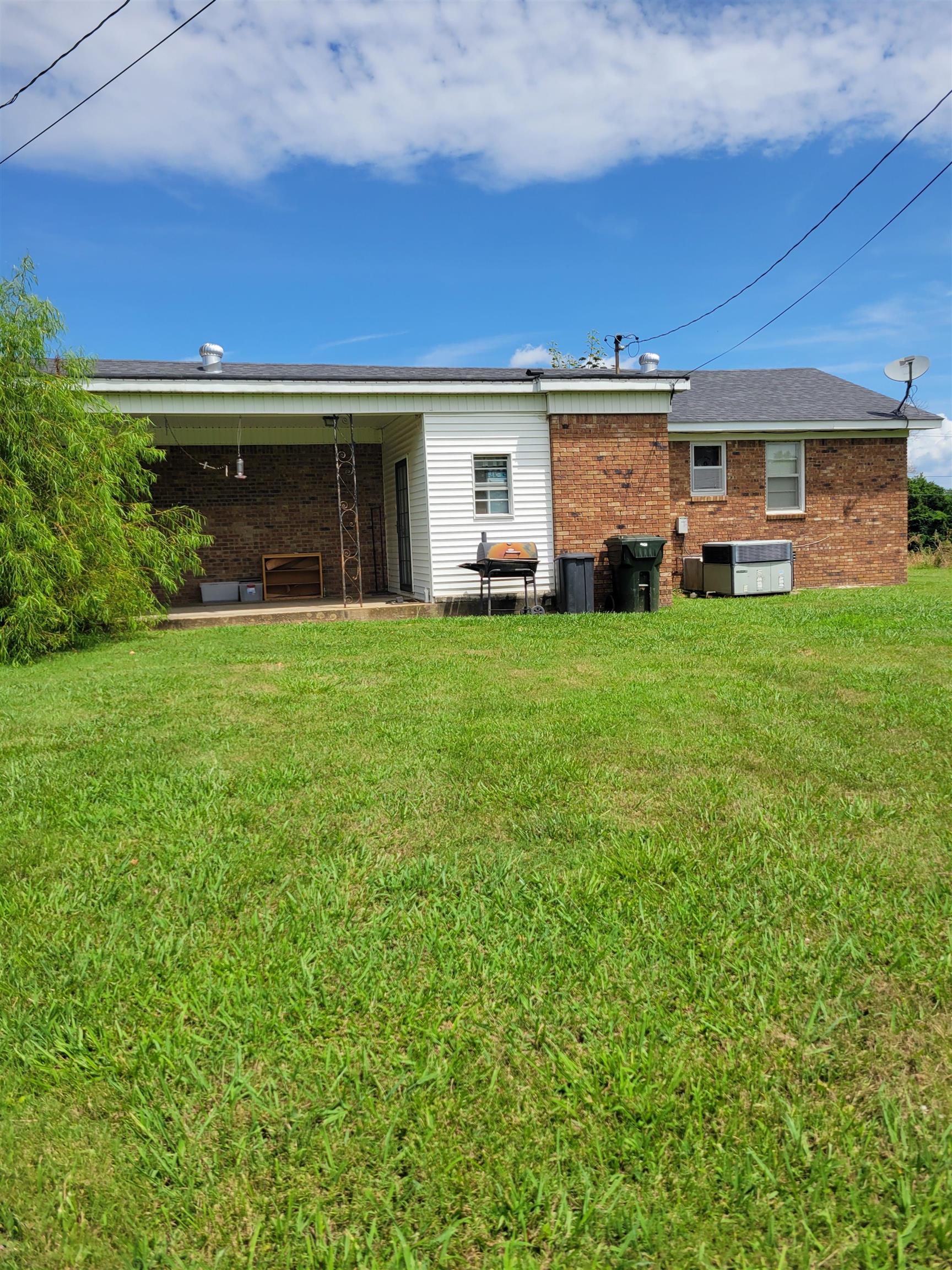 15930 Edith-Nankipoo Road Halls, TN 38040 - Photo 2 of 7 Rear view of property featuring a patio and a yard