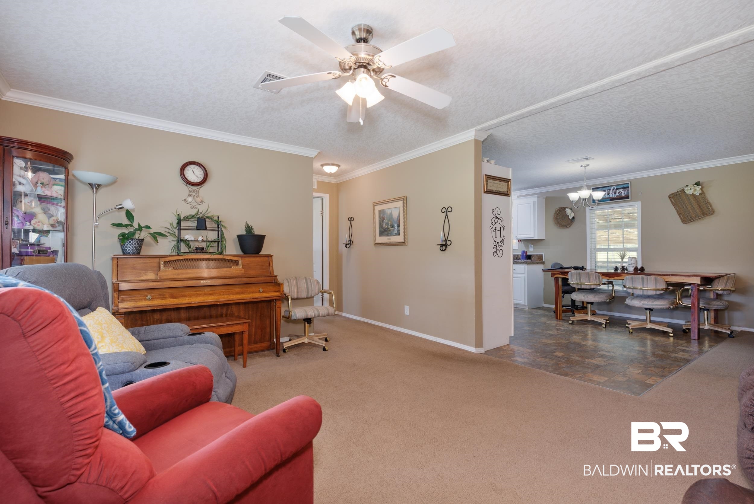 6725 Upper Creek Road Flomaton, AL 36441 - Photo 35 of 61 Living room with crown molding, baseboards, carpet flooring, a ceiling fan, and a textured ceiling