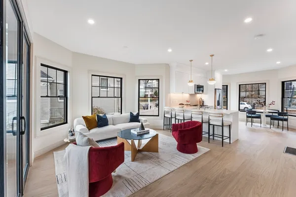 a living room with lots of furniture and wooden floor