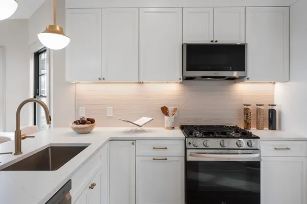 a kitchen with stainless steel appliances a sink a stove and microwave