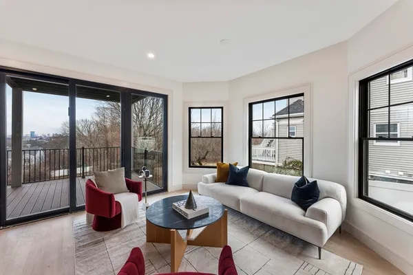 a living room with furniture and a floor to ceiling window