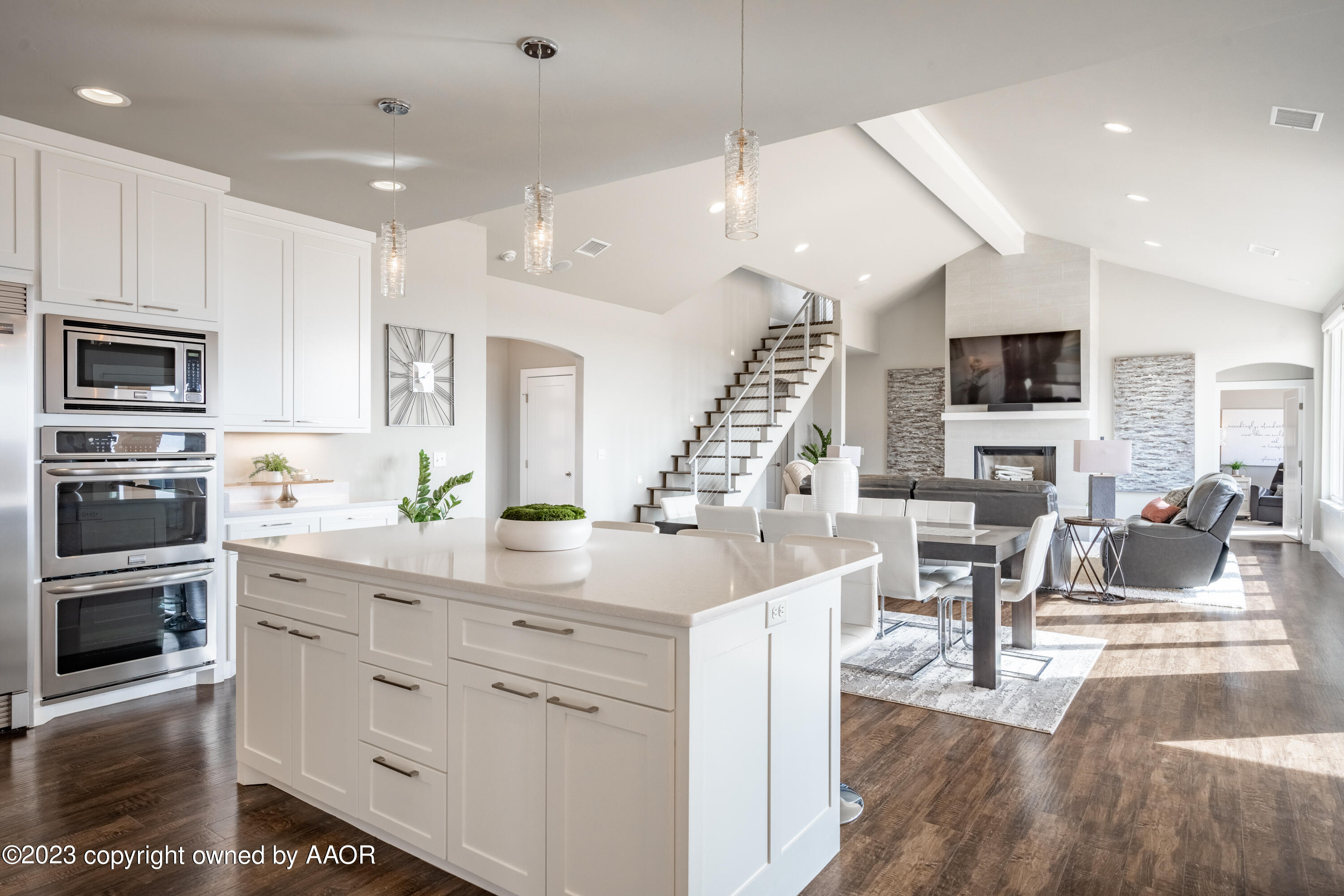 15300 Canyon Pass Road Amarillo, TX 79118 - Photo 16 of 51 a kitchen with stainless steel appliances kitchen island granite countertop a stove top oven a sink a dining table and chairs with wooden floor