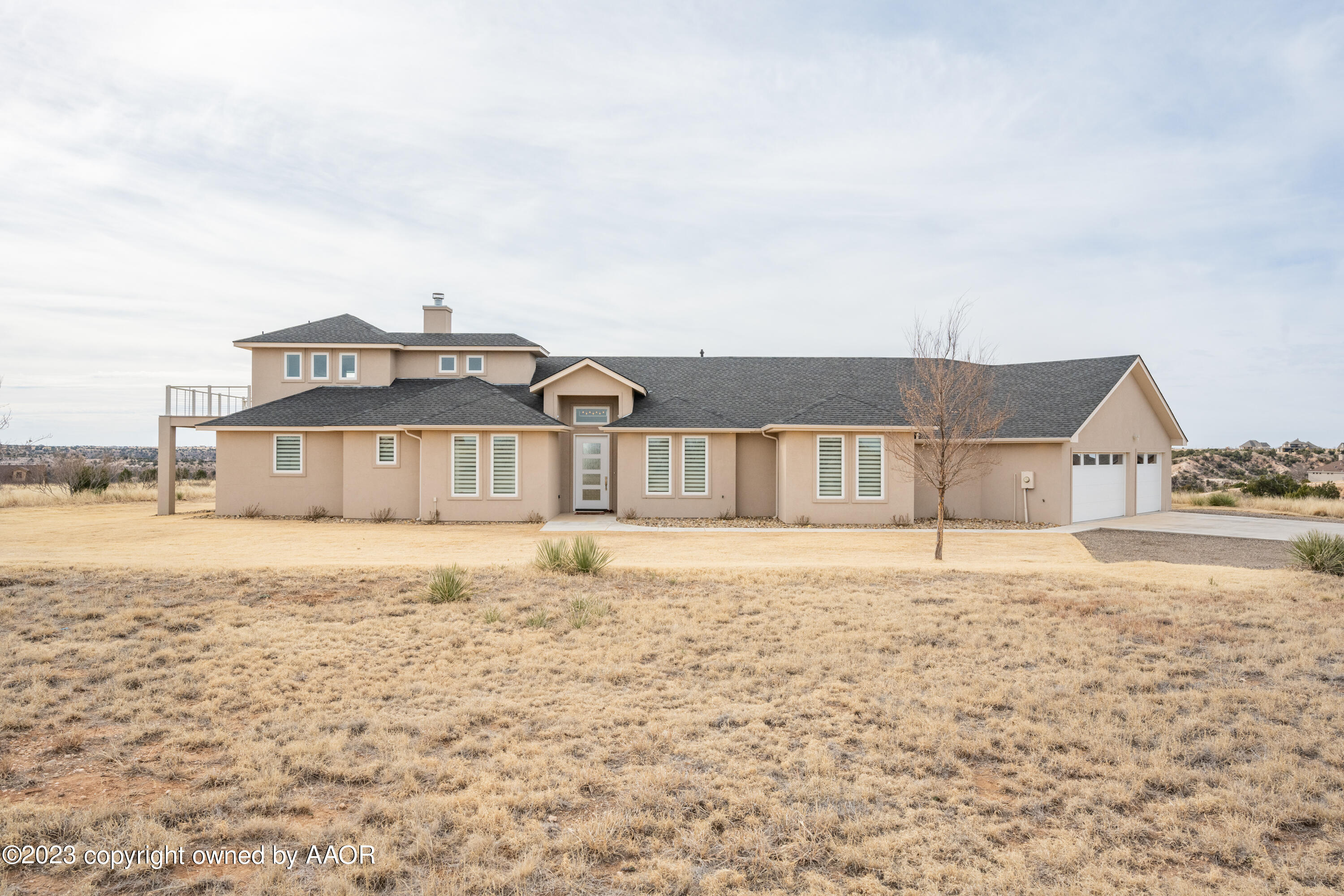 15300 Canyon Pass Road Amarillo, TX 79118 - Photo 2 of 51 a large house with a big yard and large trees