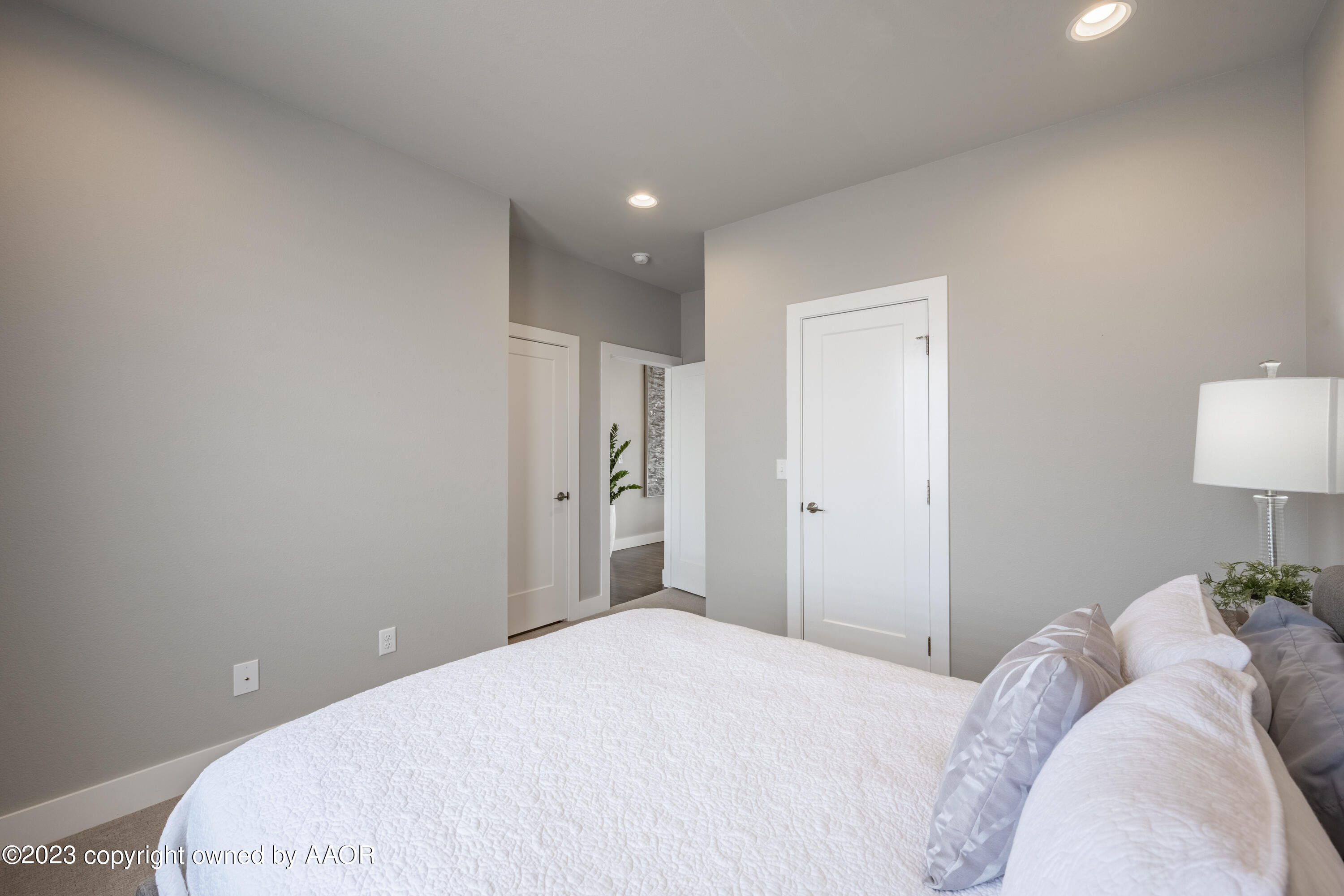 15300 Canyon Pass Road Amarillo, TX 79118 - Photo 33 of 51 a bedroom with a bed and a lamp