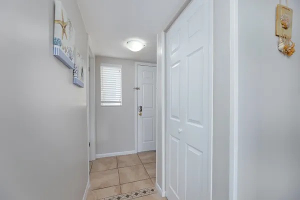a bedroom with a large bed and a chandelier fan