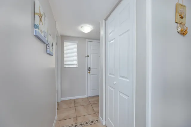 a bedroom with a large bed and a chandelier fan