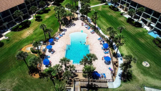 a view of swimming pool with outdoor seating and potted plants